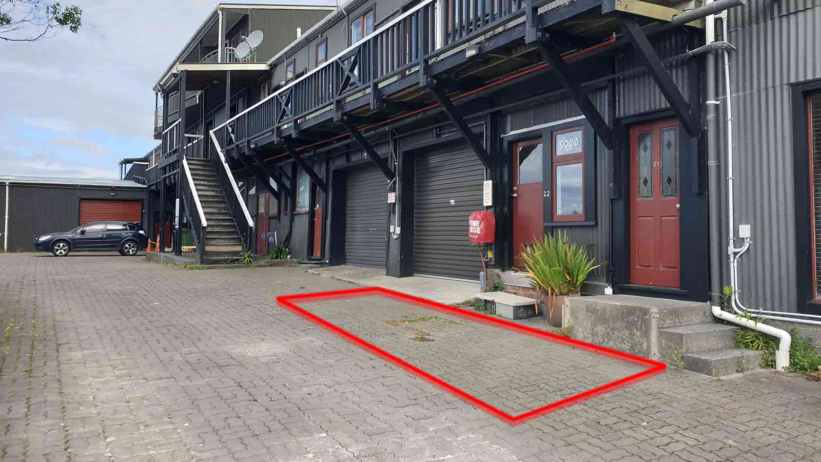 Red square showing location of carpark available for squid parking outside of a garage door.